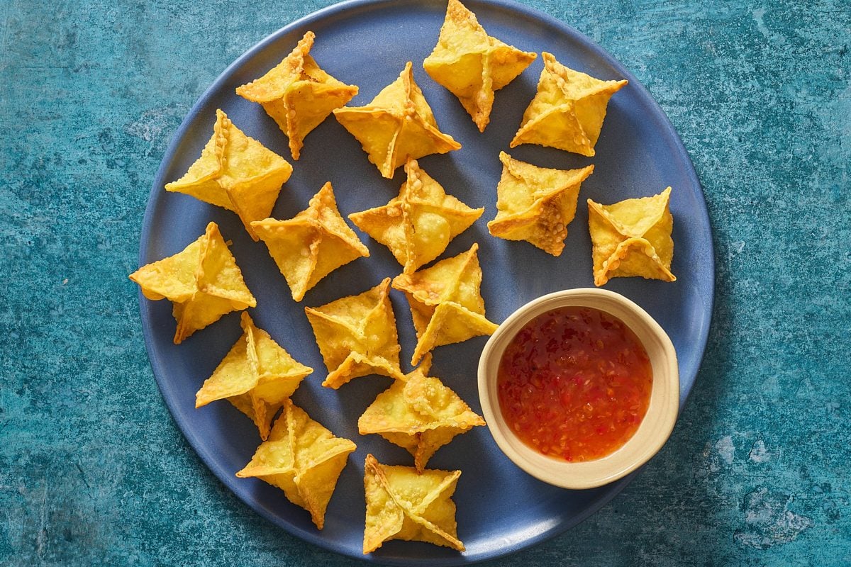 Overhead shot of shrimp rangoon on a plate with some dipping sauce