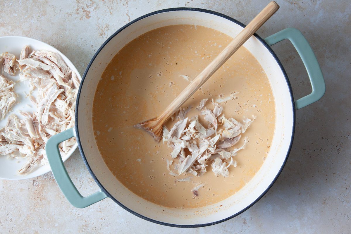 Adding chicken to curry soup base in a Dutch oven