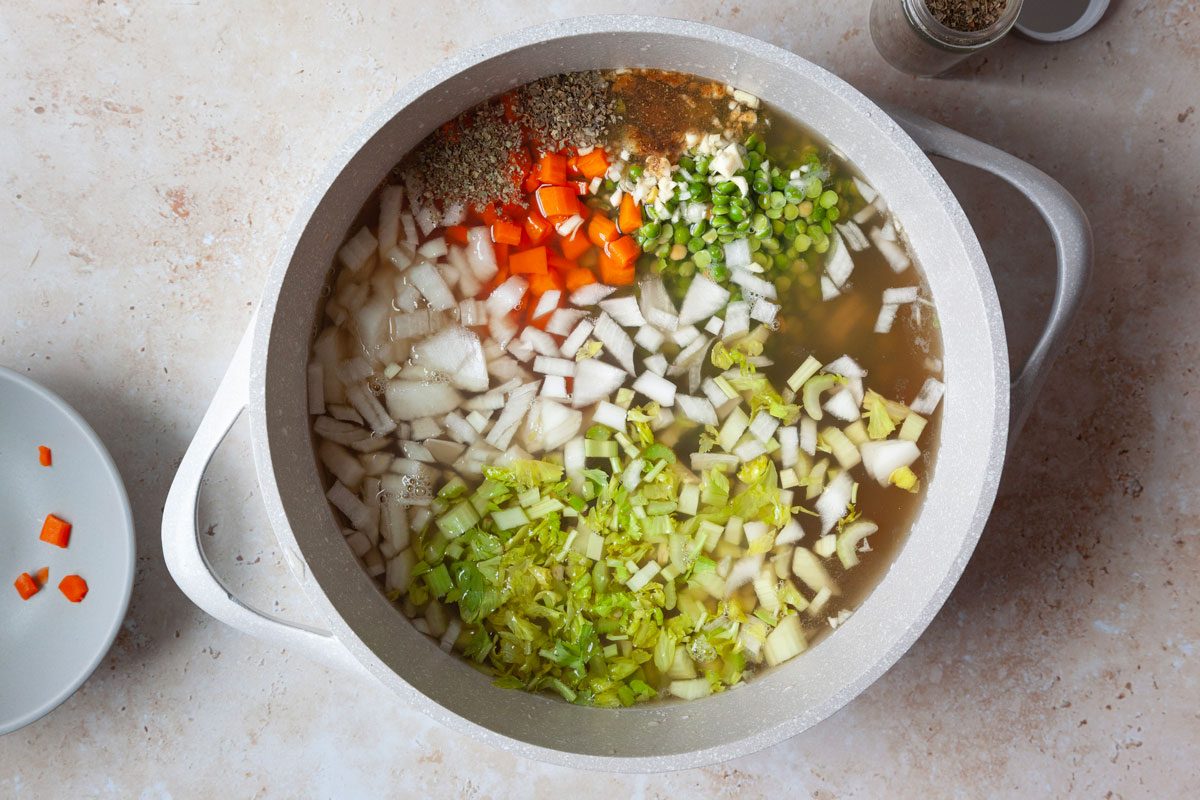 First step of Taste of Home Vegetarian Split Pea Soup is to combine the first nine ingredients into a Dutch oven and bring to a simmer