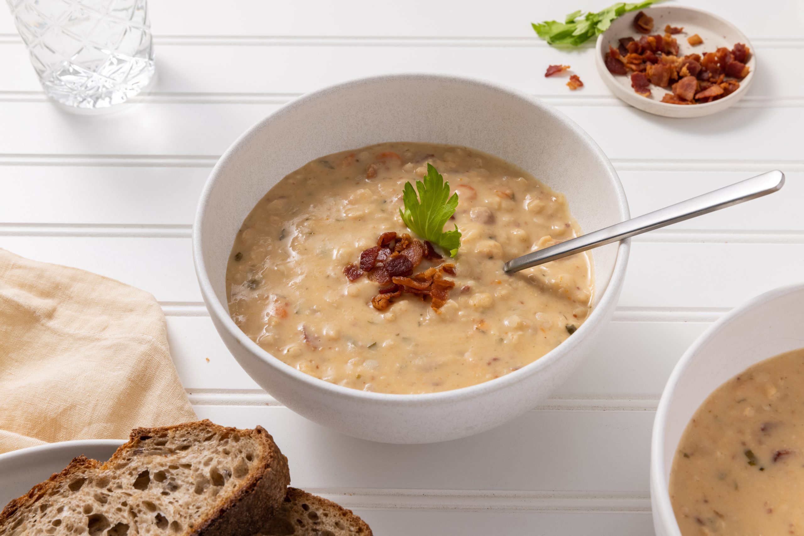 Yankee bean soup served in bowl with spoon. 