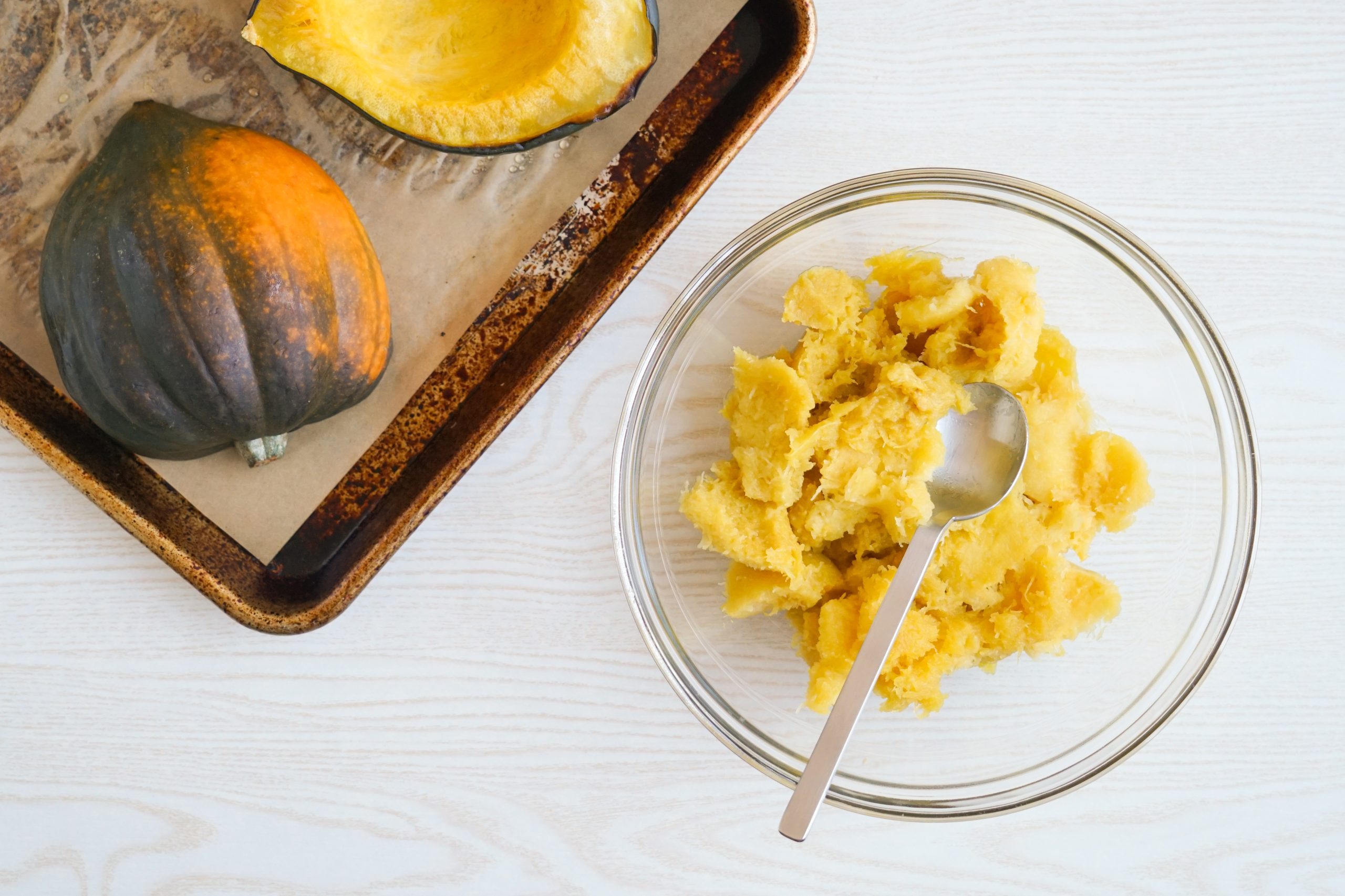 Scooping roasted acorn squash flesh out
