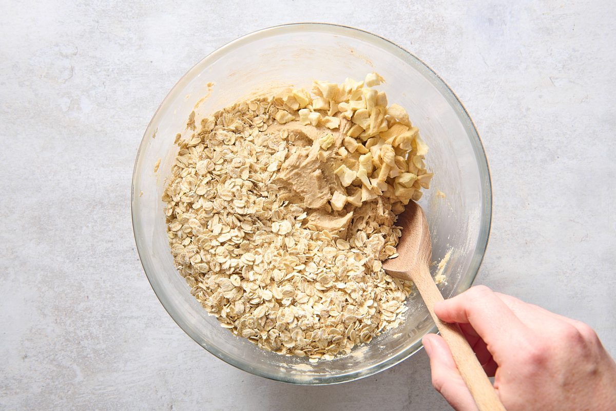 Stirring apples and oats into the cookie batter