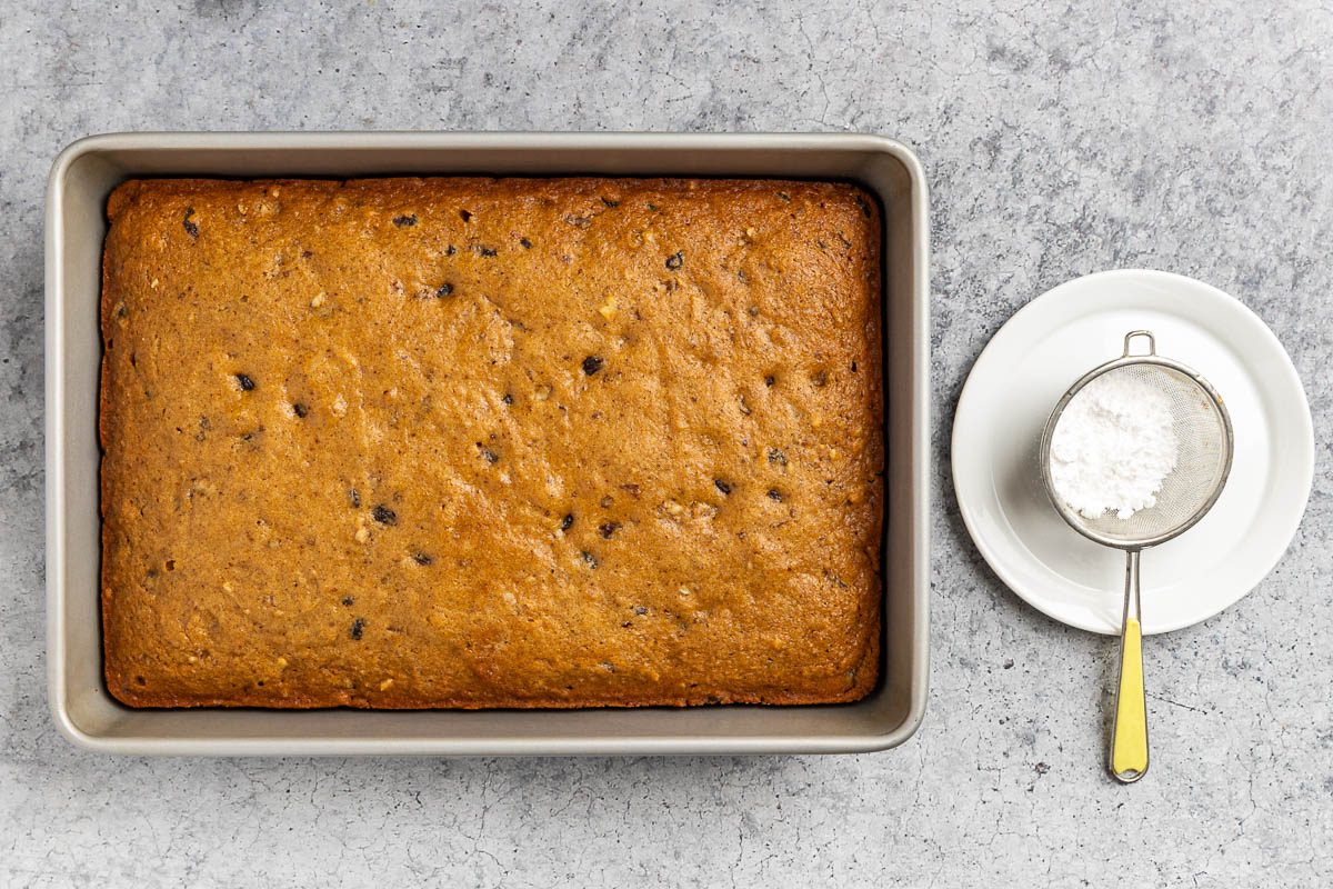 Taste of Home Applesauce Cake photo of the baked cake with confectioners' sugar.