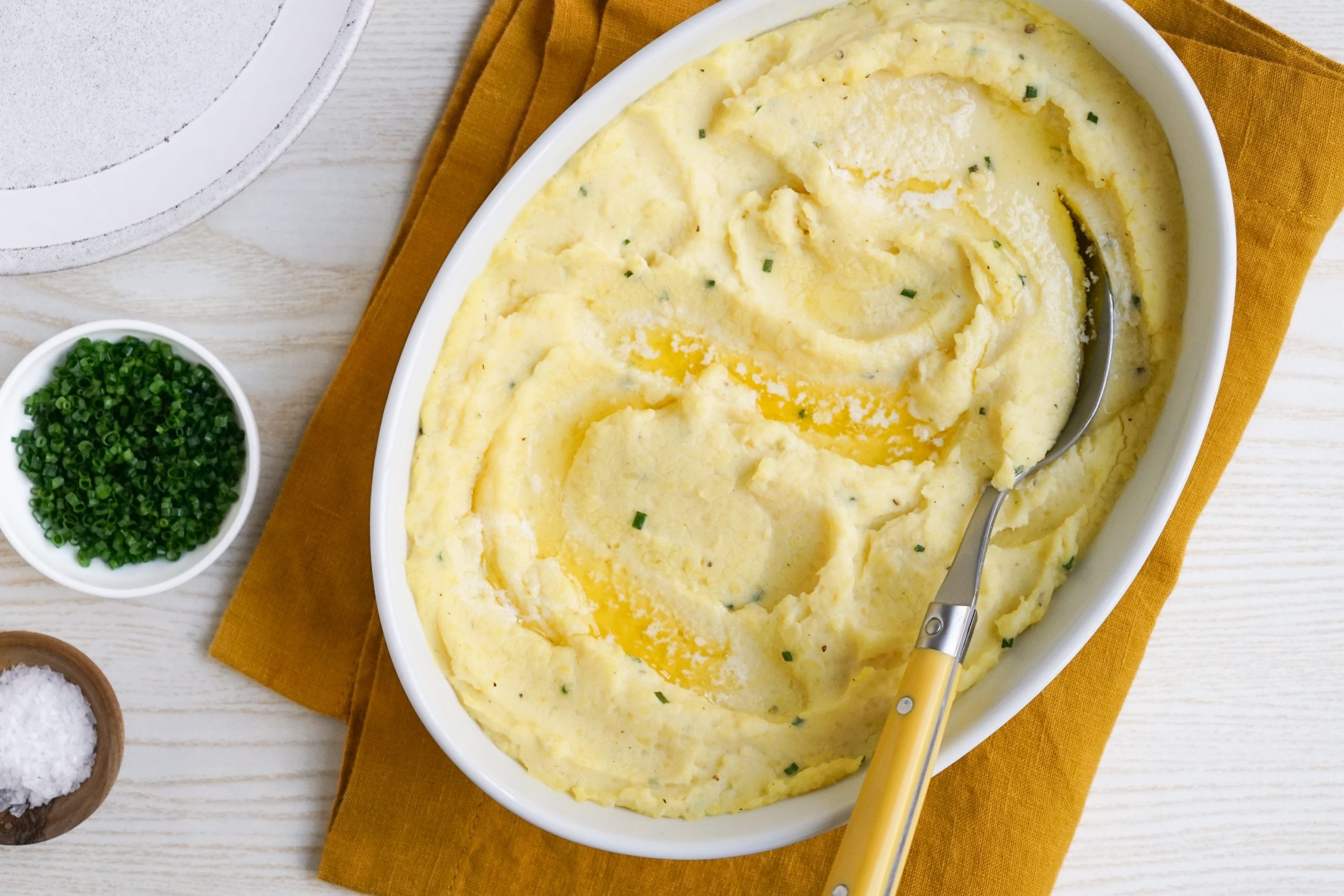 Baked mashed potatoes with chive garnish
