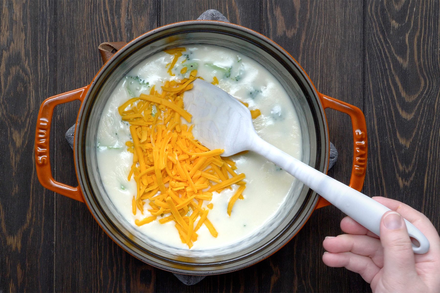 overhead shot; wooden background; added broccoli and sprinkled cheese over the dish;