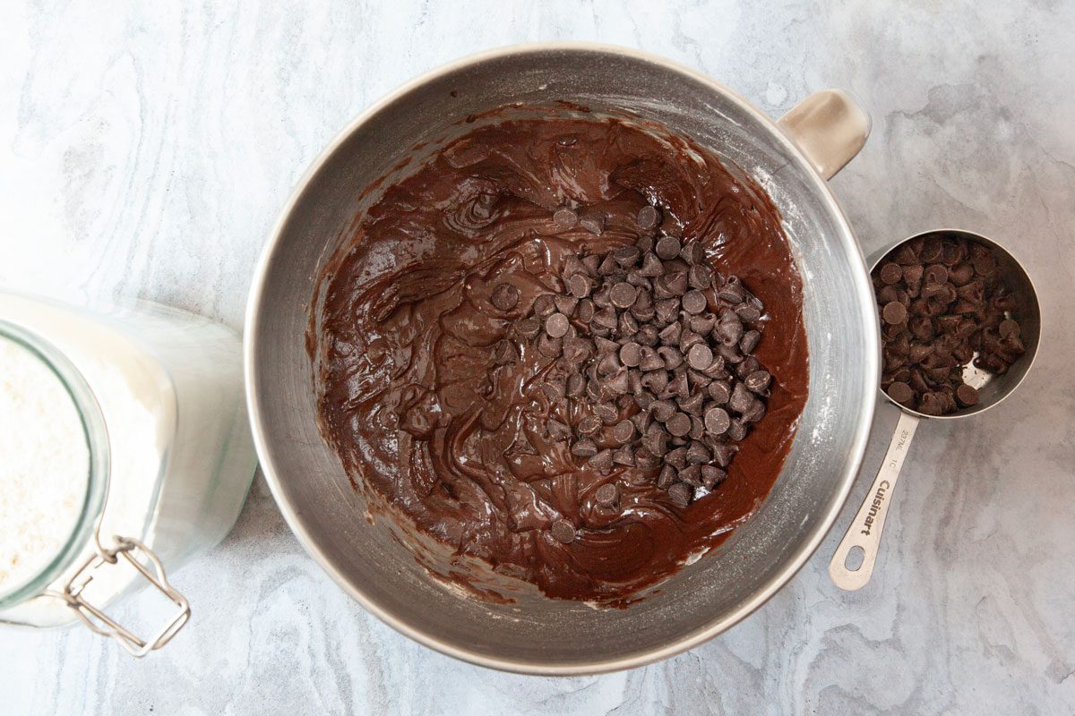 Step 1 of Taste of Home Brownie Mix Cookies is to In a large bowl, beat the brownie mix, flour, egg, water and oil until it's well blended. Stir in the chocolate chips, then let the dough stand for 30 minutes.