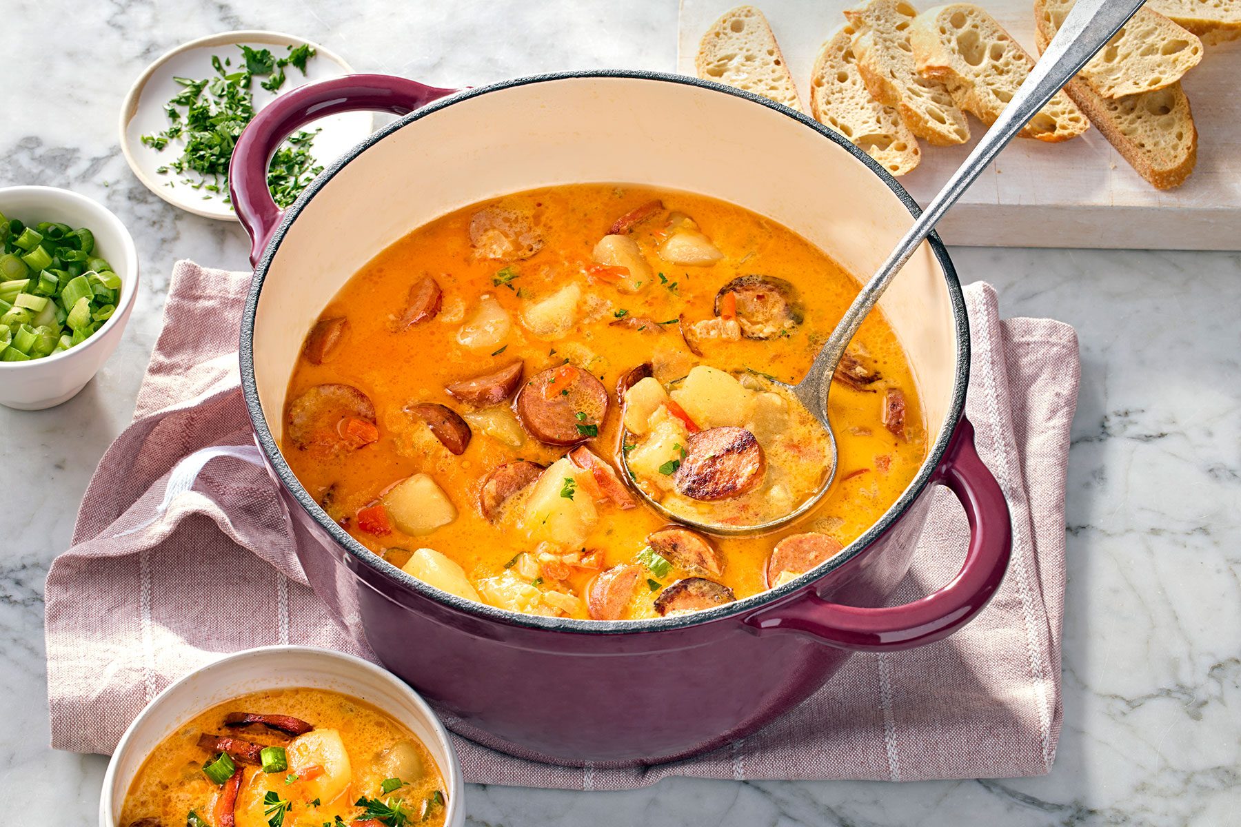 wide shot of cajun potato soup served with parsley in a dutch oven