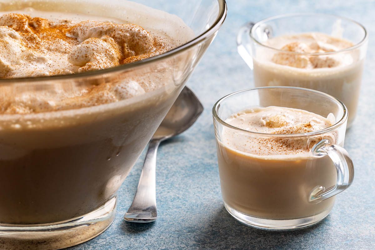 Taste of Home coffee punch recipe photo of ingredients combined into punch bowl filled with vanilla ice cream and served into two glass mugs.