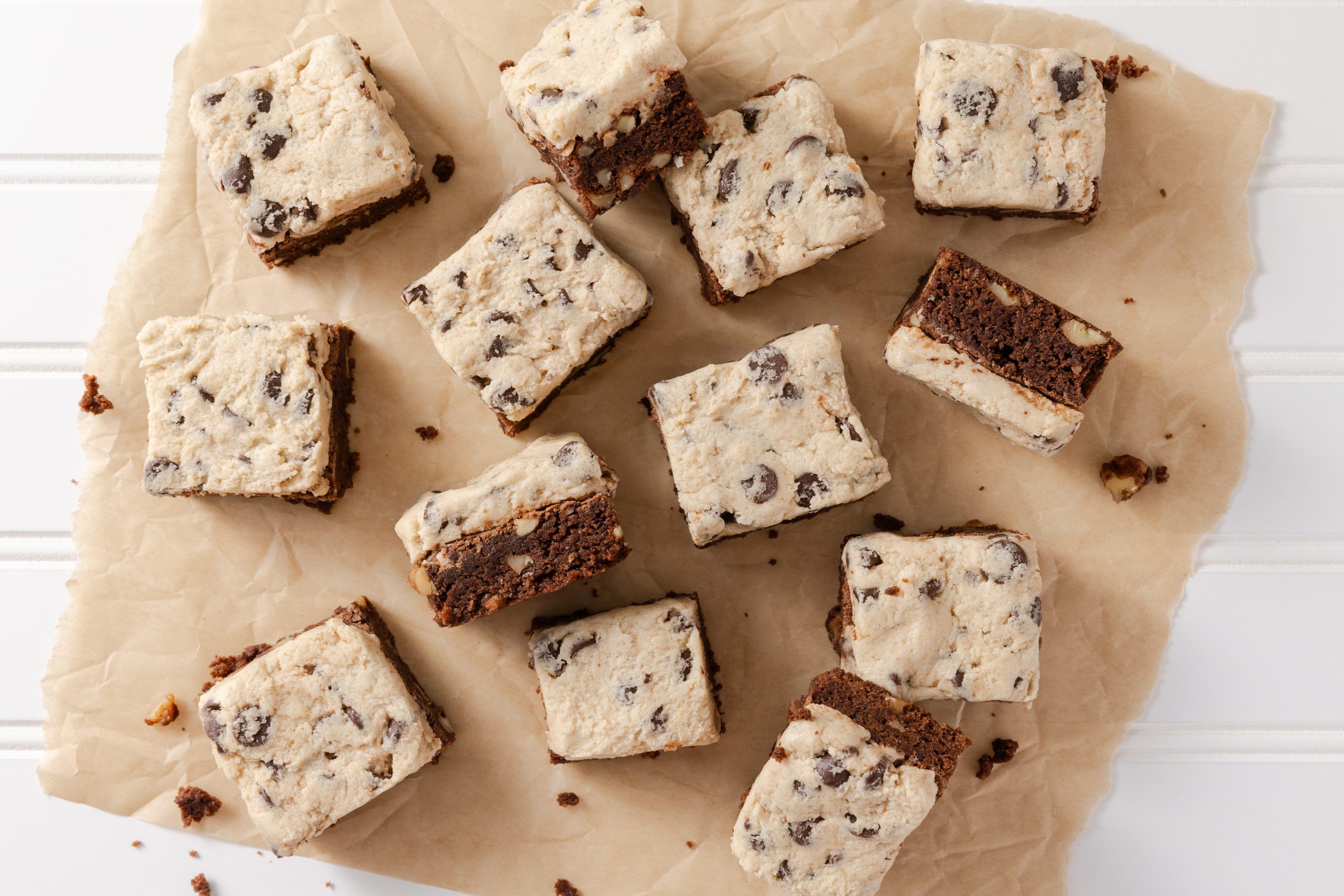 Cookie dough brownies ready, spread in parchment paper.