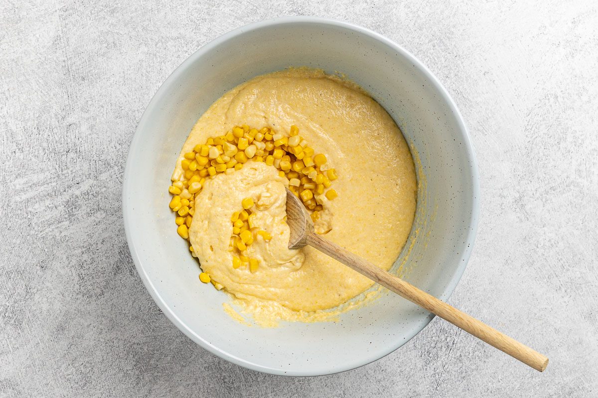 Taste of Home Corn Muffin Recipe photo of the wet and dry ingredients combined with whole kernel corn added.