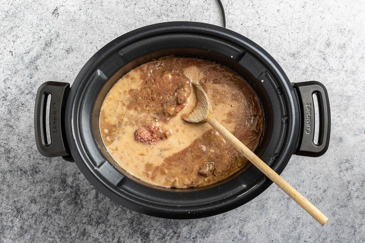 Taste of Home Cubed Steak in Crock Pot recipe photo of adding cornstarch to the crock pot to make the gravy.