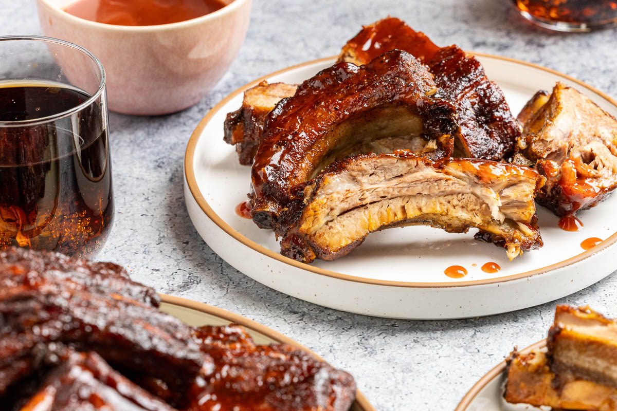 Taste of Home Dr Pepper ribs recipe photo of the final recipe served on a platter and plates.