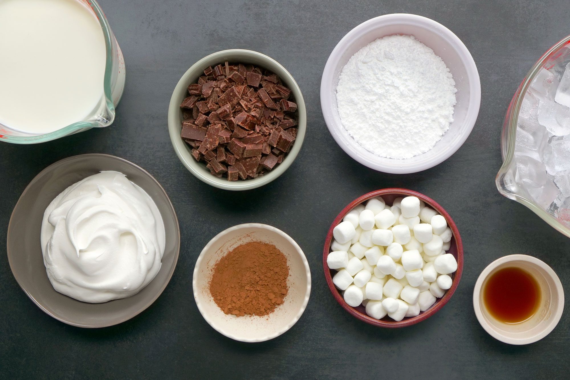 Overhead Shot of All Ingredients for Frozen Hot Chocolate on Dark Grey Surface