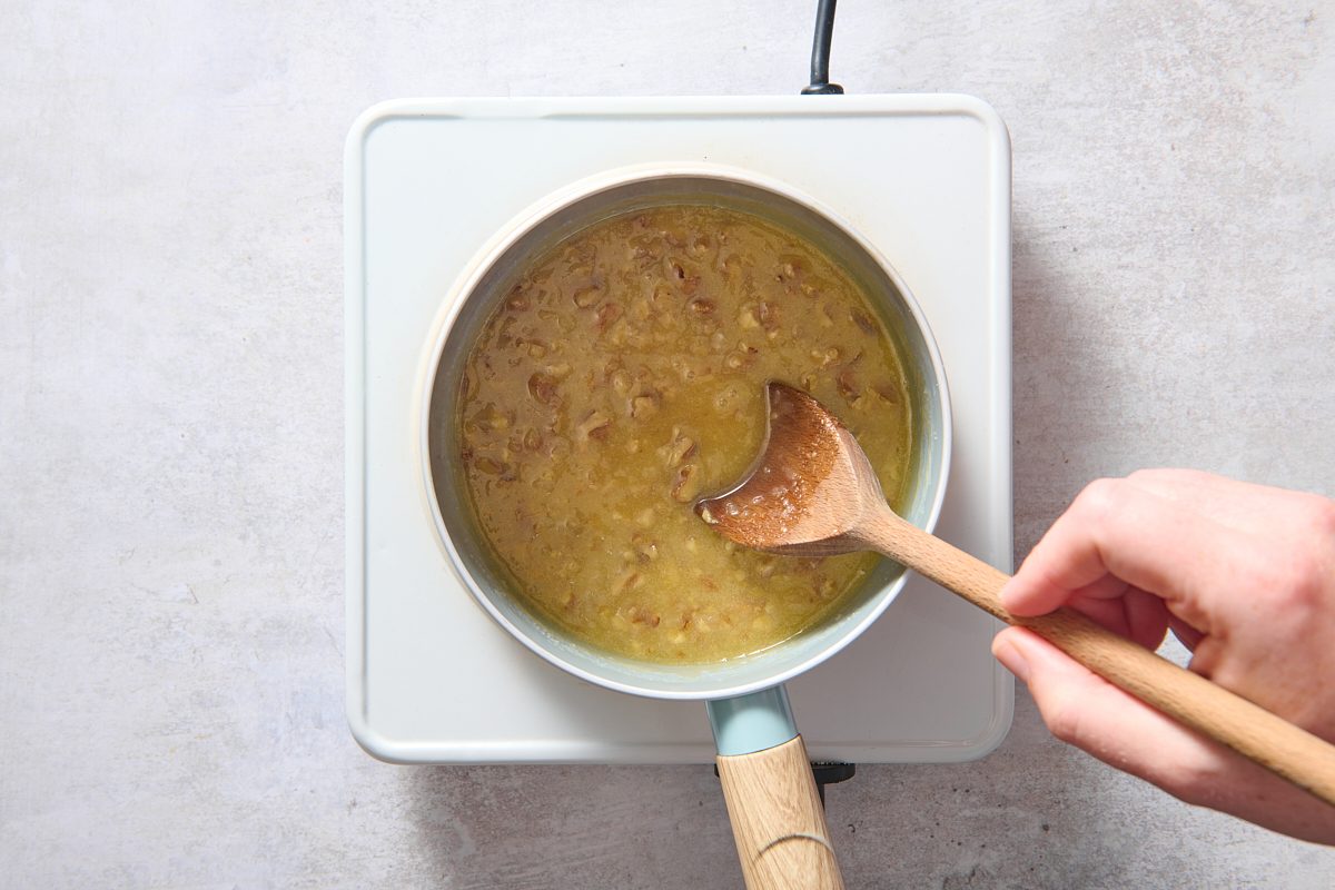 Stirring sauce ingredients in a small saucepan