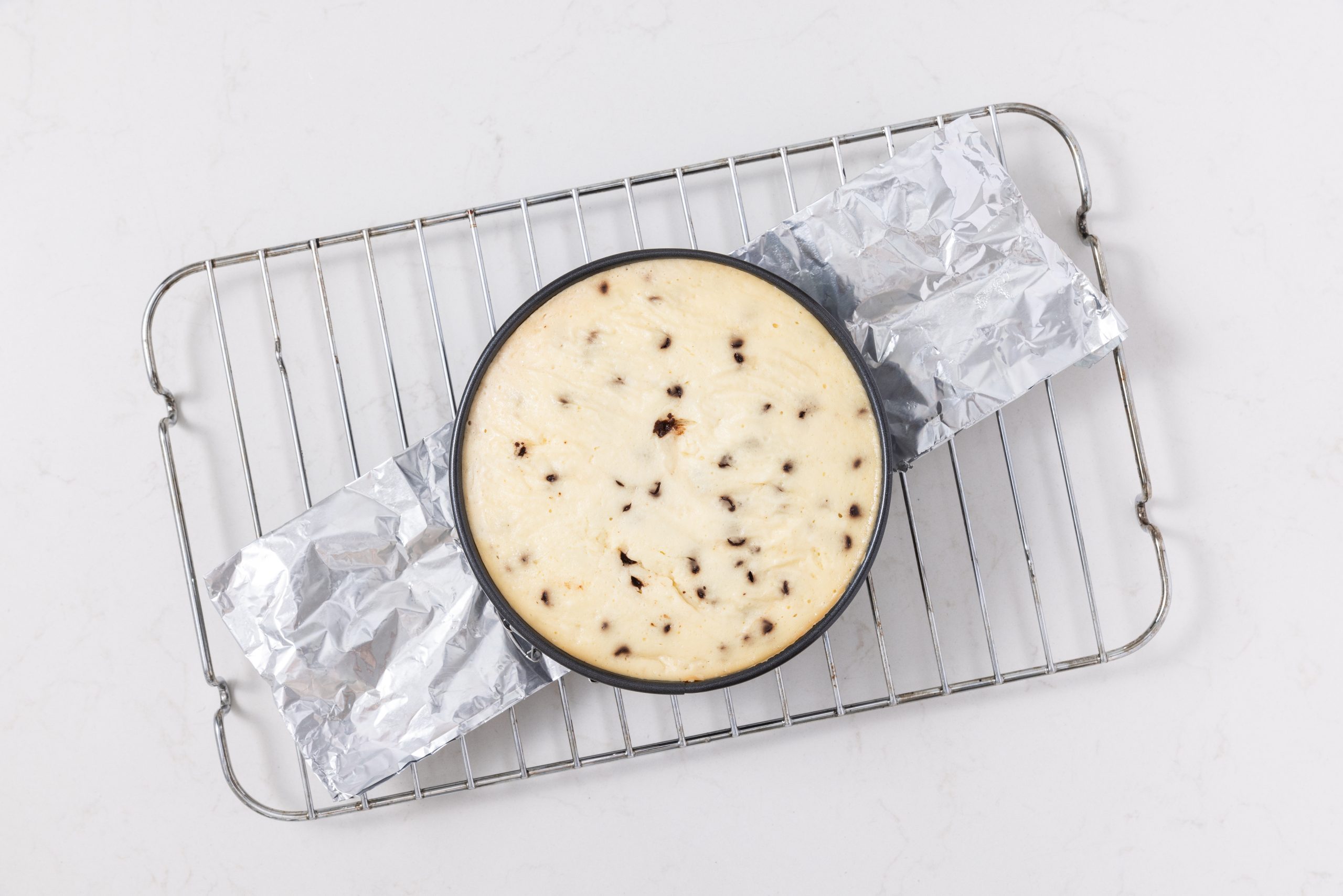 Cheesecake ready and cooling in wire rack.