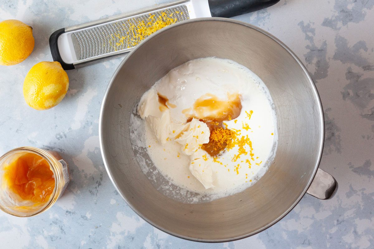 Step 3 of Taste of Home Italian Lemon Cream Cake is to beat cream and cheese until soft peaks form. Stir in the marshmallow creme, lemon curd, limoncello and lemon zest until combined