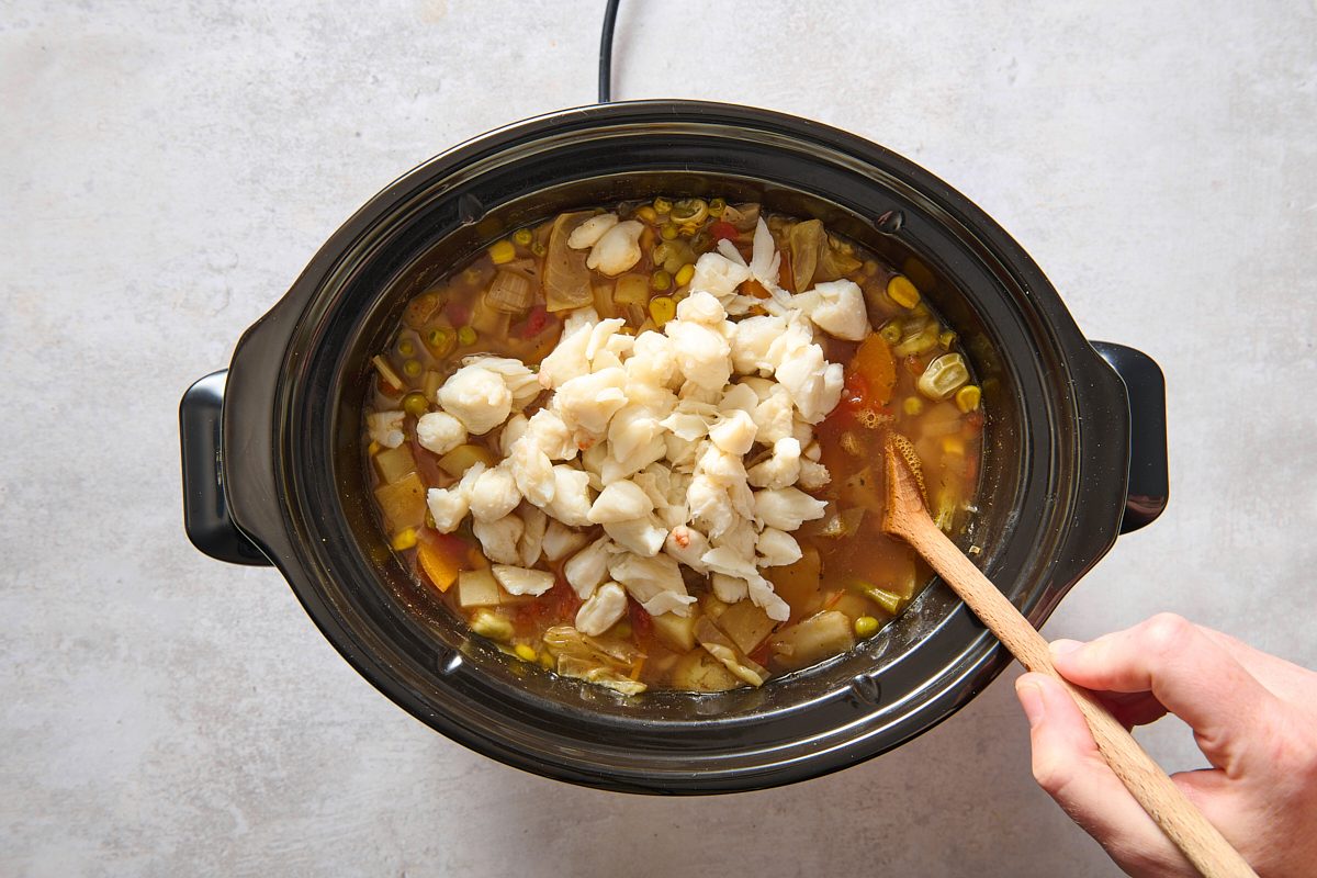 Stirring the crab into the slow cooker