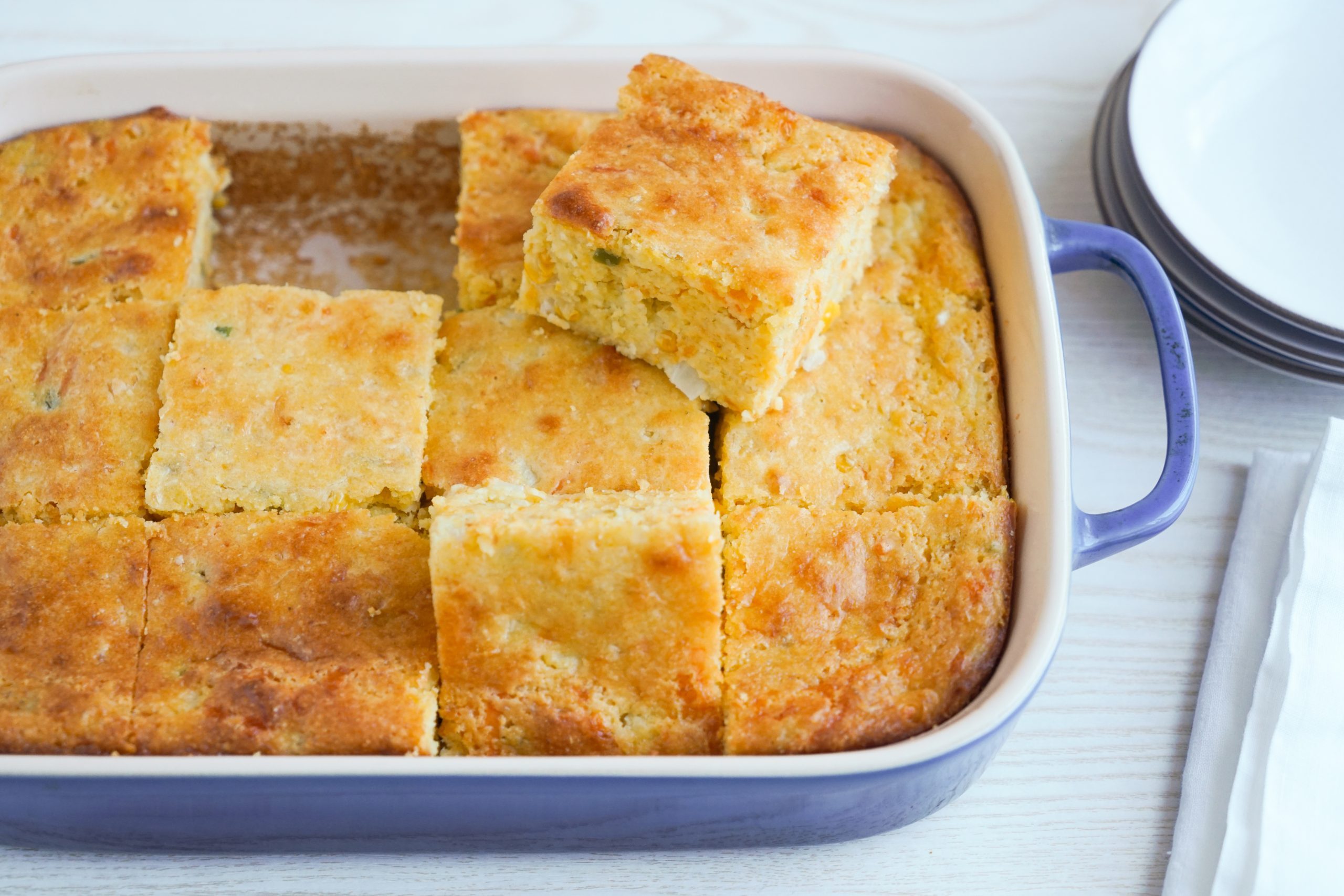 Sliced Mexican cornbread in a casserole dish