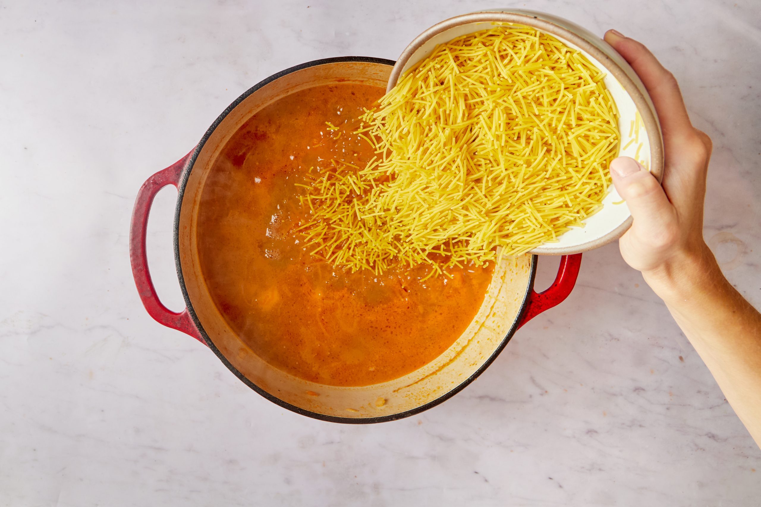 Add the noodles to the Spanish chicken soup.