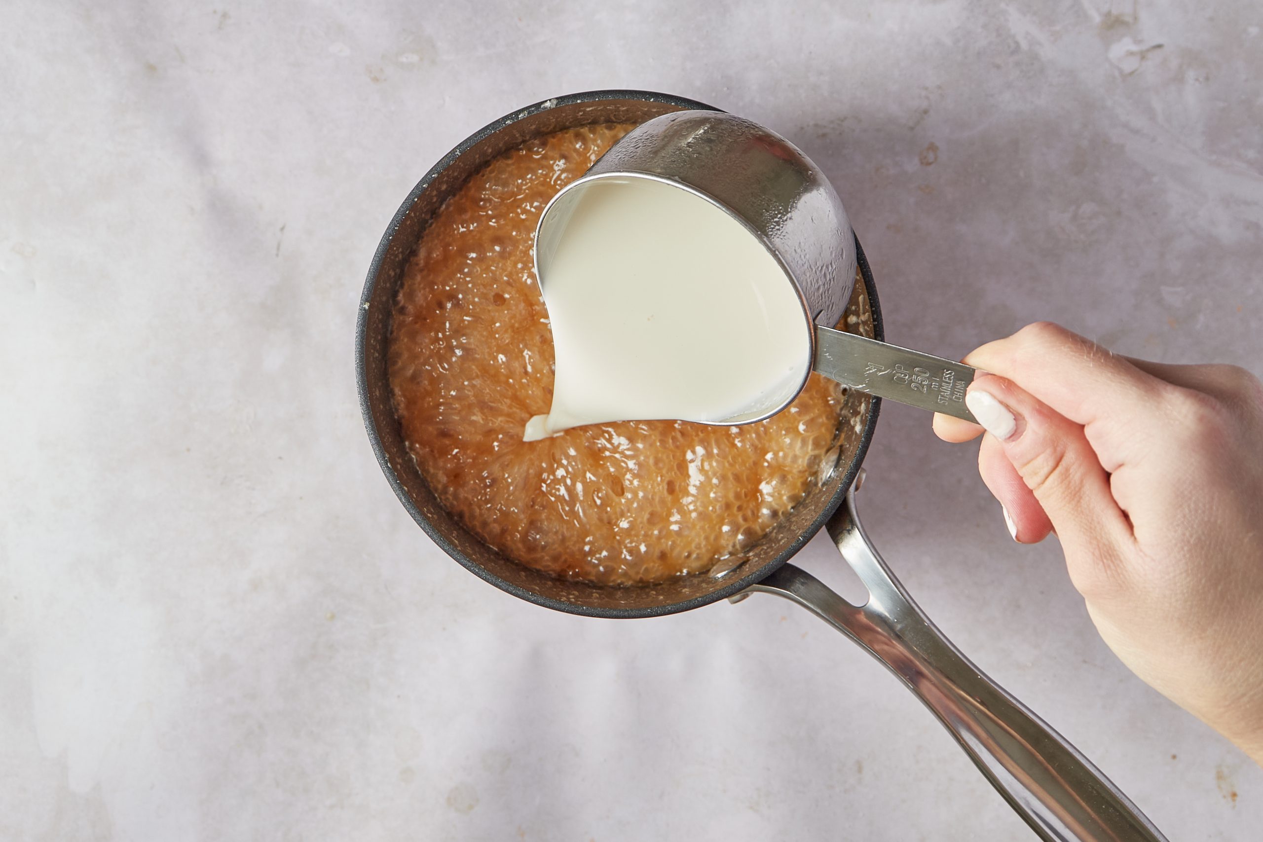 Make the caramel sauce for the praline ice cream.