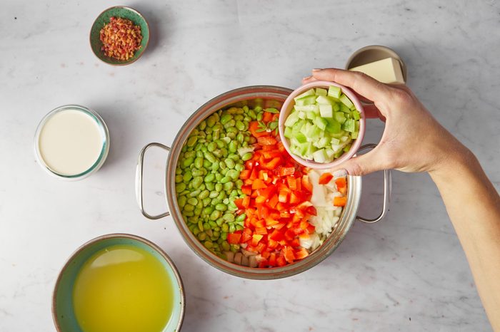 Cook the vegetables for lima bean soup.