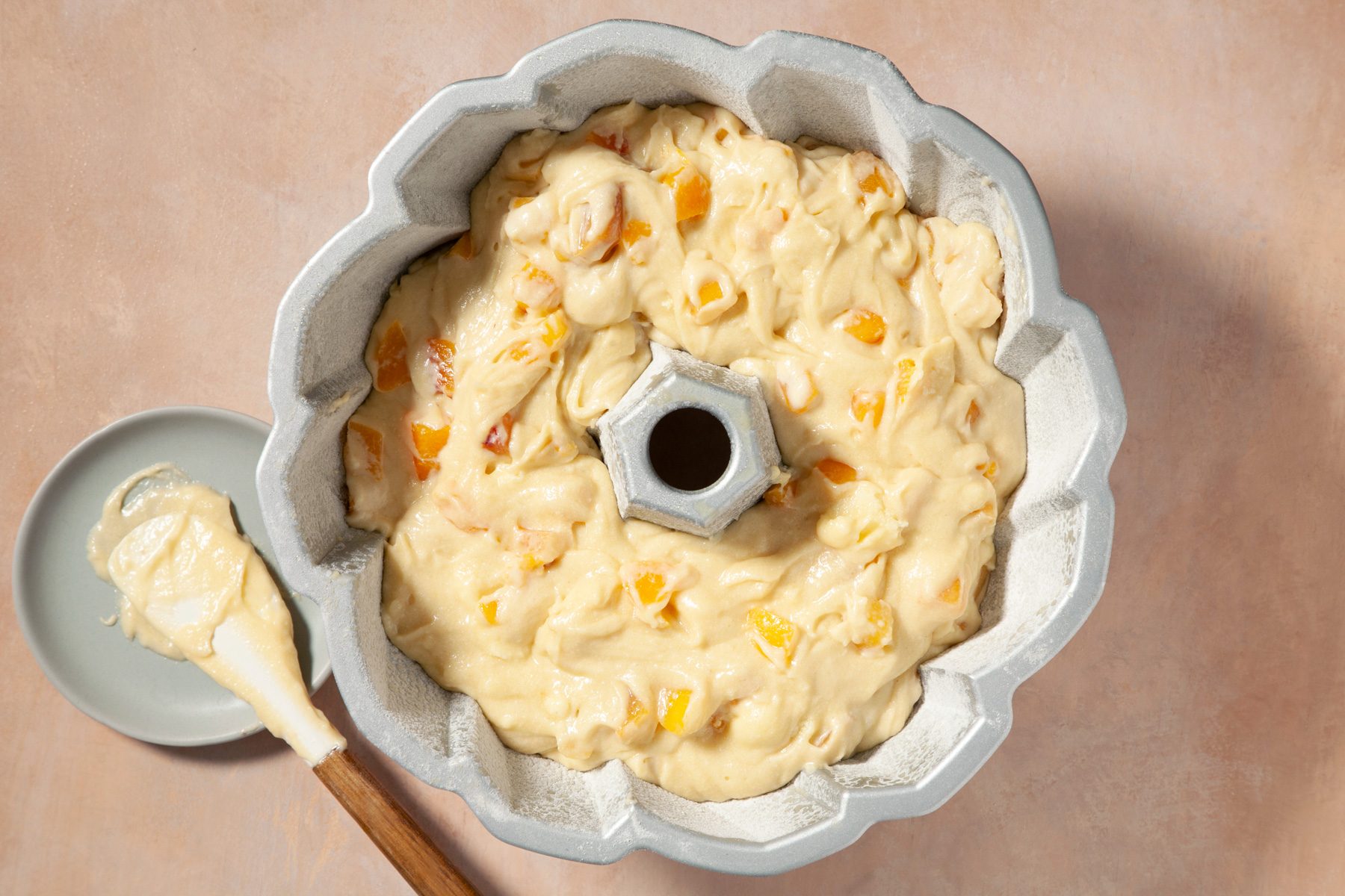 Top view shot of pouring batter in tube pan 