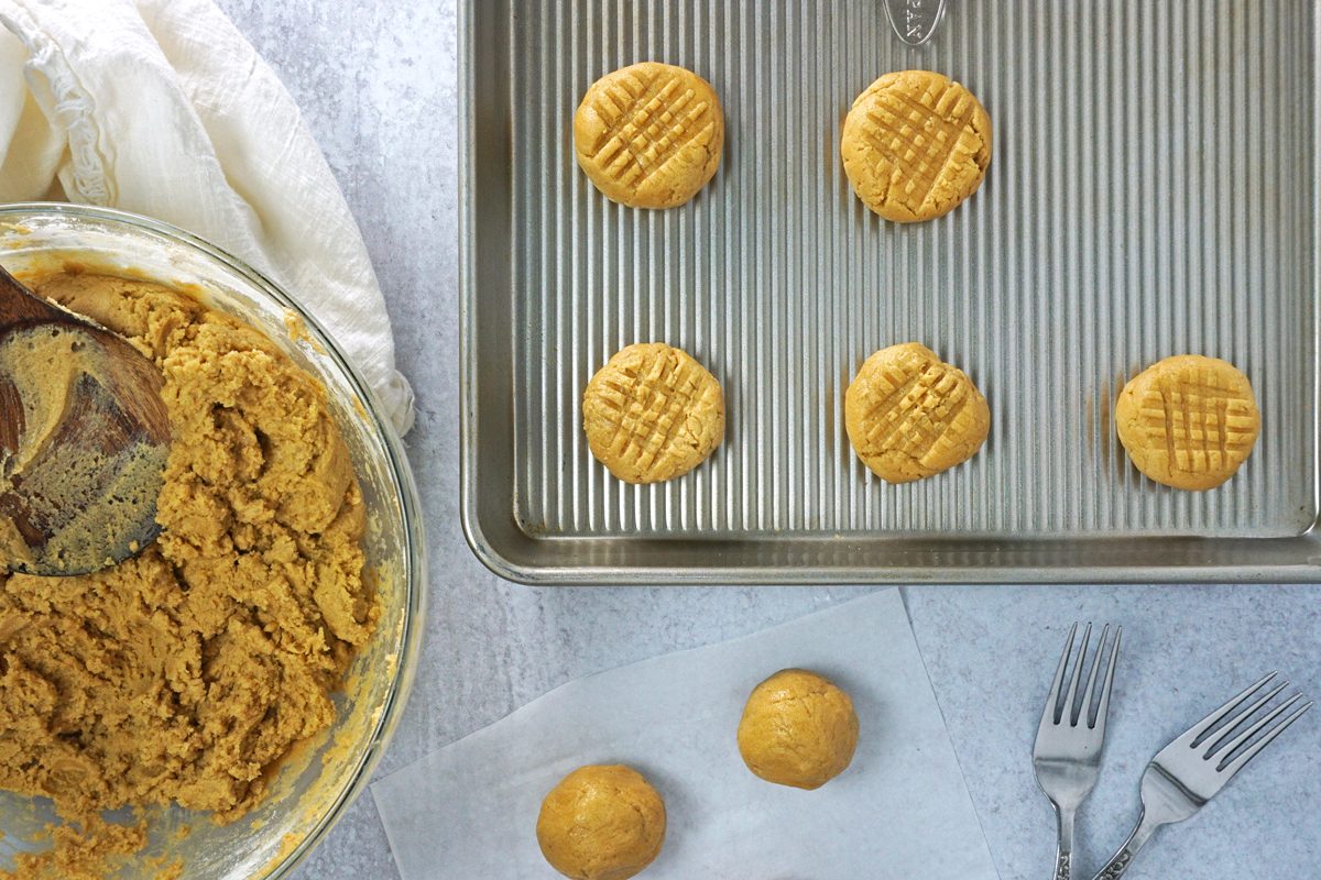 Rolling peanut butter cookies into balls and pressing with a fork for Taste of Home RMS 7873