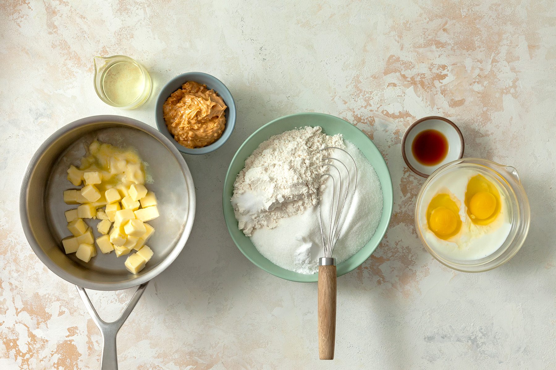 overhead shot; white textured background; Peanut Butter Sheet Cake ingredients placed over background;