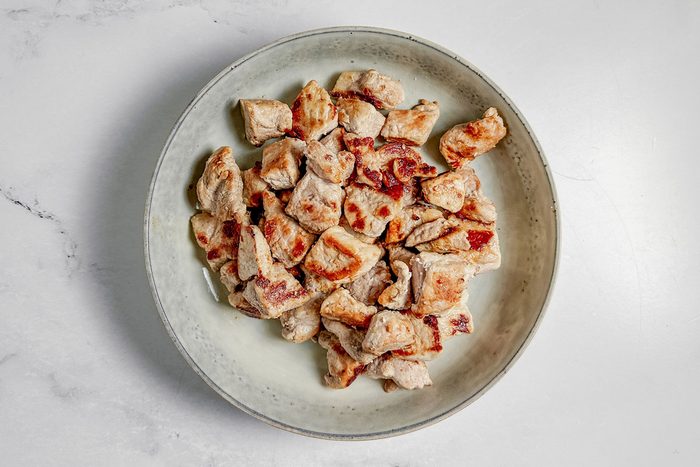 Browned pork in a ceramic bowl for Taste of Home pork stroganoff