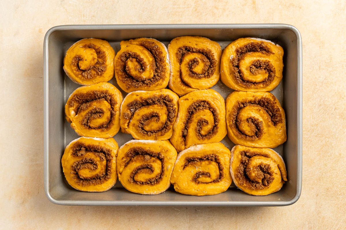 Taste of Home Pumpkin Cinnamon Rolls recipe photo of the sliced rolls in a baking pan.