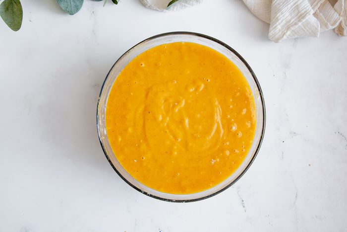 Overhead shot for Taste of Home Pumpkin Sheet Cake with cake batter mixed in a glass bowl.