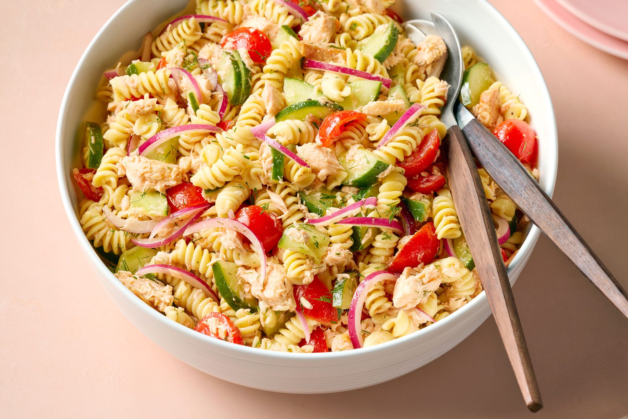 Overhead Shot of Salmon Pasta Salad Served in a large bowl on Beige Background