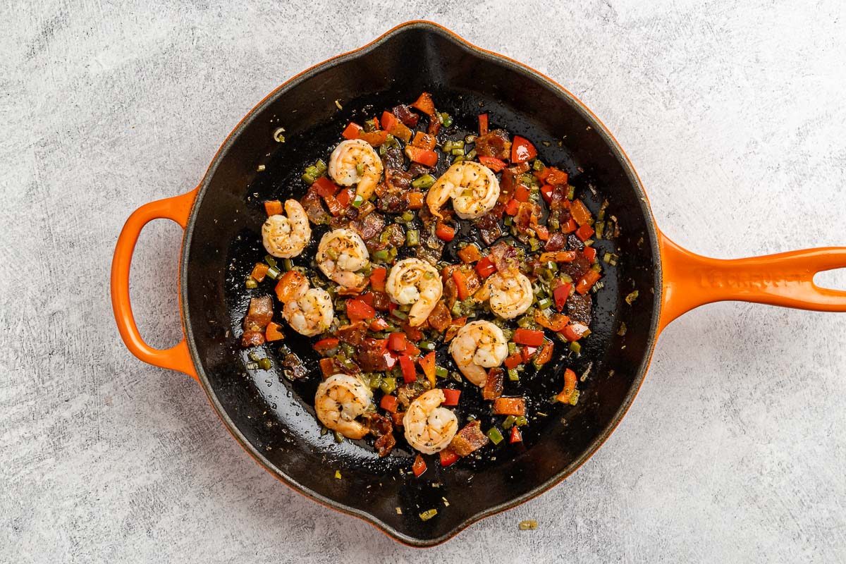 Taste of Home Shrimp Omelet recipe photo of the red pepper, jalapeno, lemon juice, herbs, onion, and shrimp sauteed in a skillet.