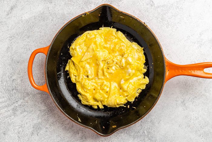 Taste of Home Shrimp Omelet recipe photo of the omelet being prepared in the skillet.