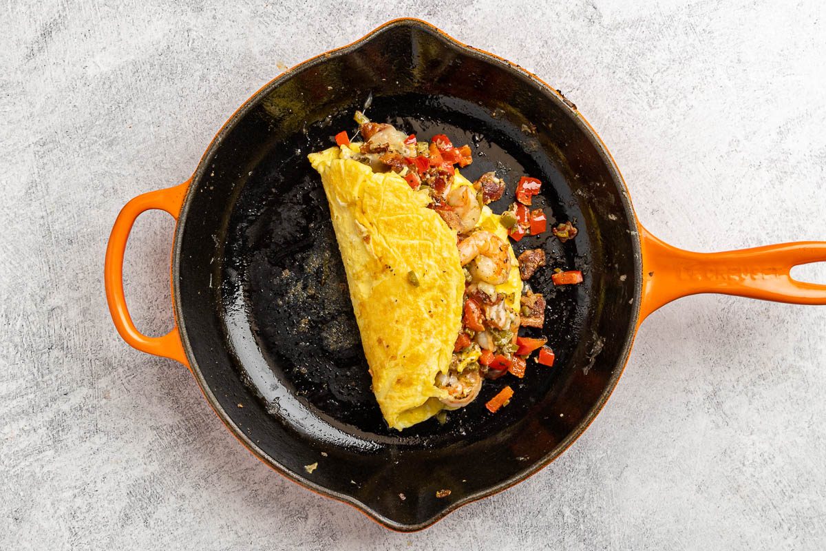 Taste of Home Shrimp Omelet recipe photo of the stuffing added to the omelet and folded in half.