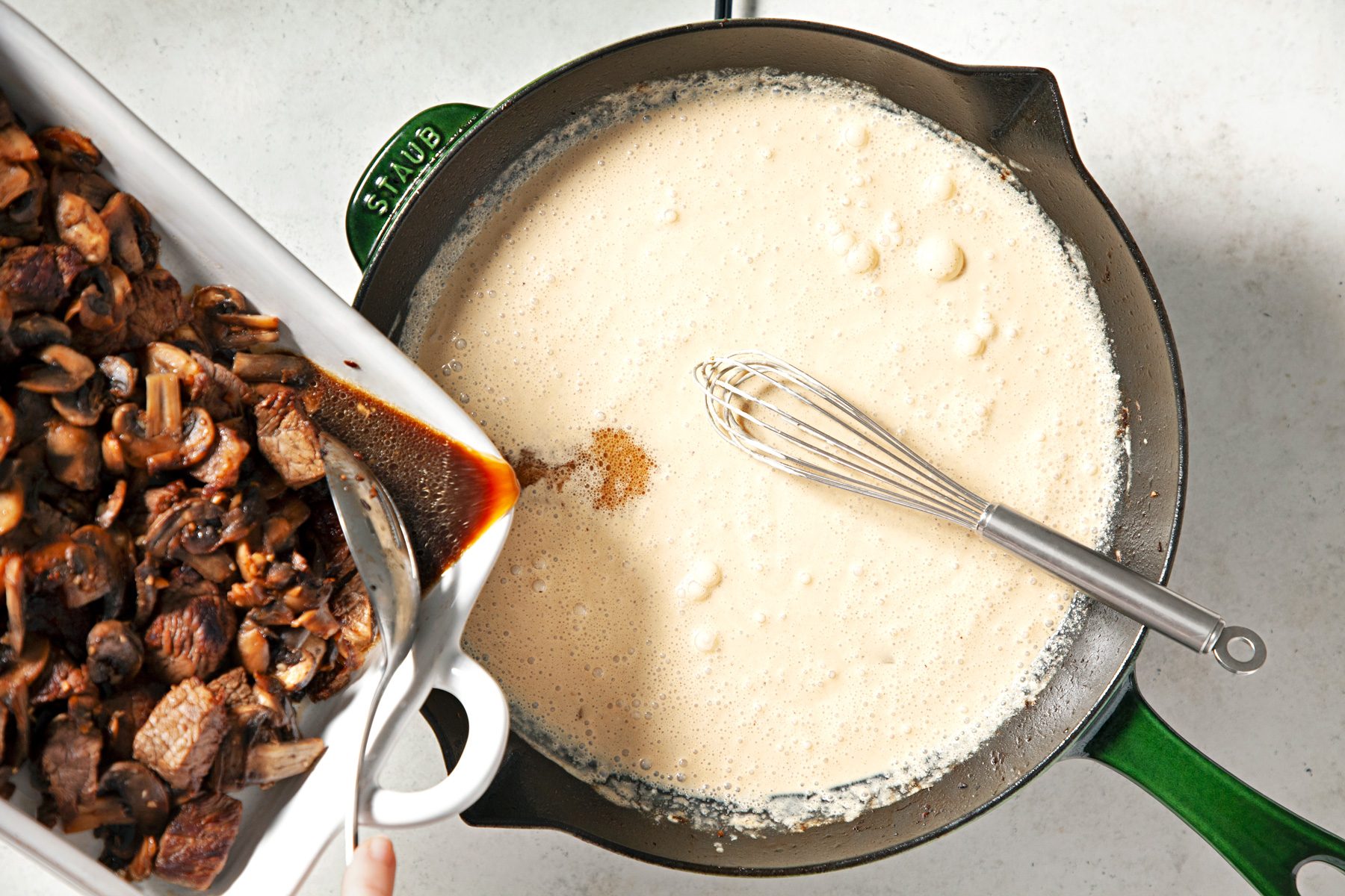 Drain juices from baking dish into broth mixture.