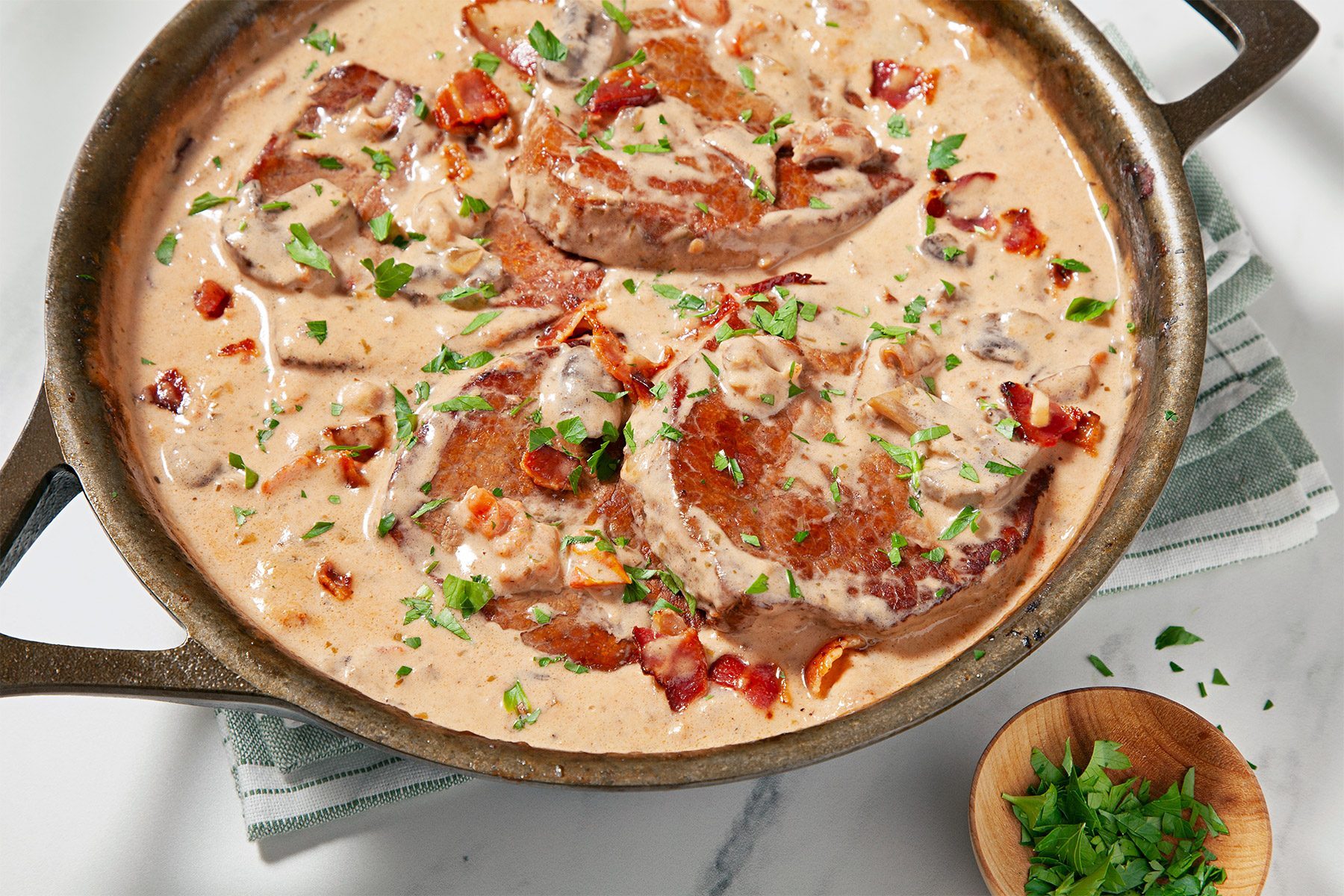wide shot of oven swiss meat garnished with fresh parsley