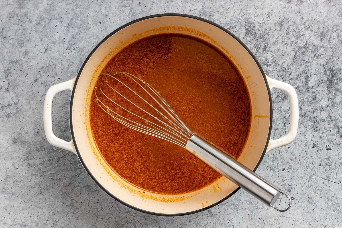 Taste of Home Thai Curry Soup recipe photo of the chicken broth, cocount milk, and soy sauce added to the dutch oven.