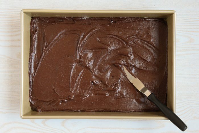 Spreading brownie batter into a baking pan