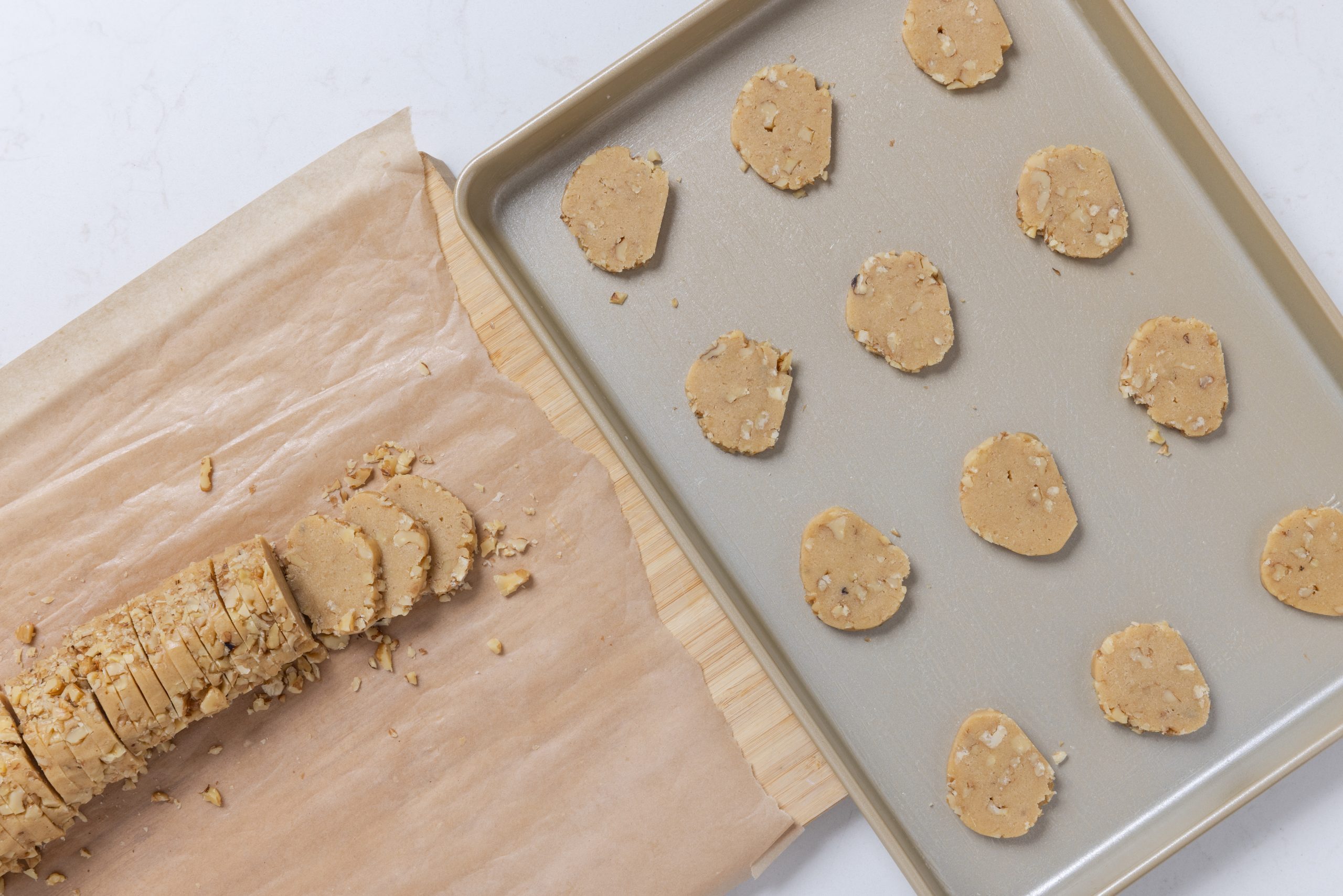 Cookies being cut and placed on greased baking sheet.