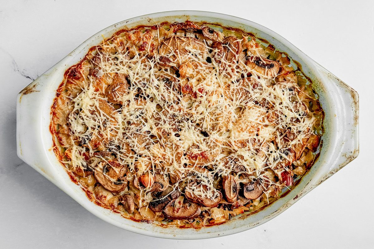 Taste of Home wild rice casserole in a pyrex dish on a marble surface.