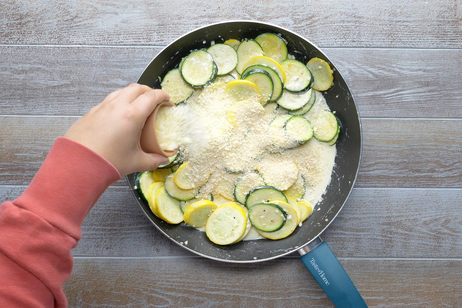 overhead shot of bread crumbs added in the cooked zucchini