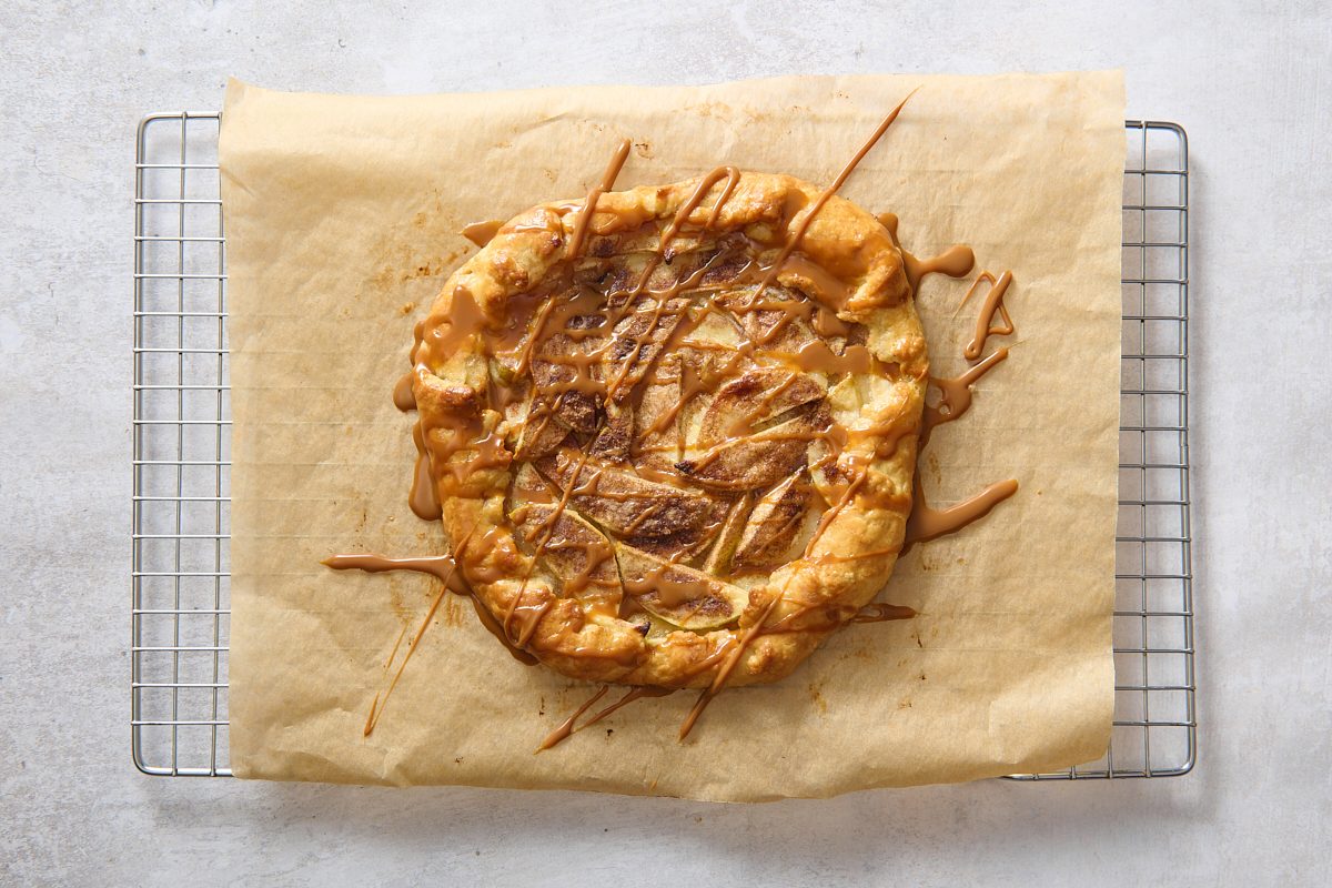 Baked apple crostata topped with caramel sauce