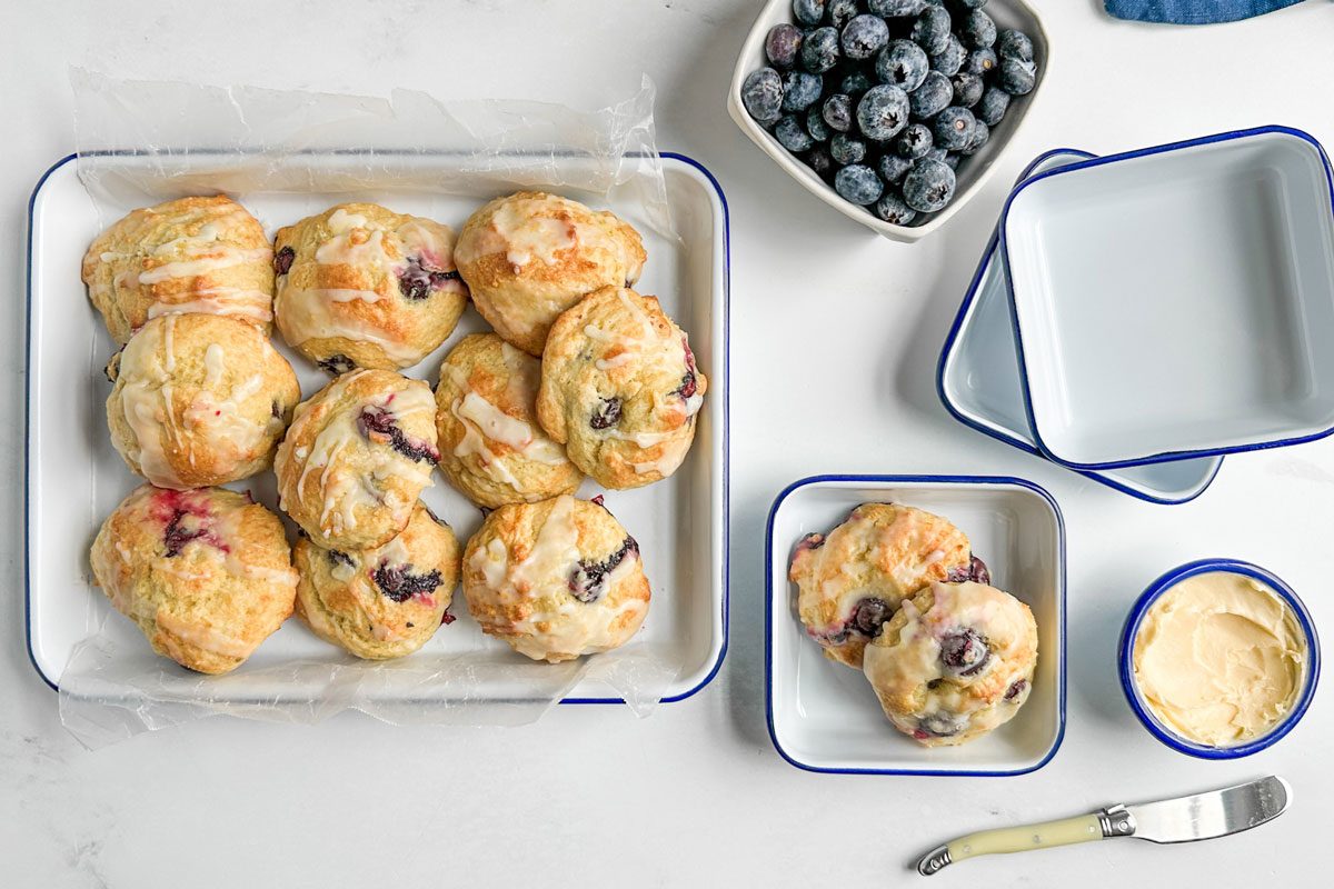 Taste of Home Blueberry Biscuits on enamal dishes on a marble surface