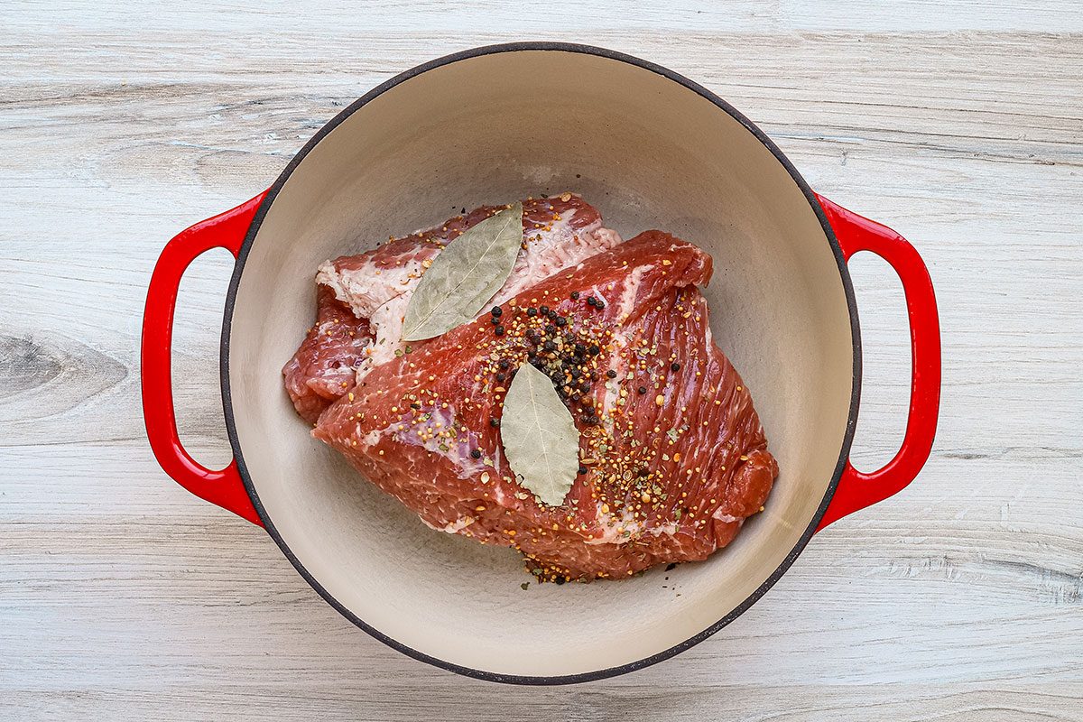A boiled dinner preparation with bay leaves and spices, from a Taste of Home recipe.
