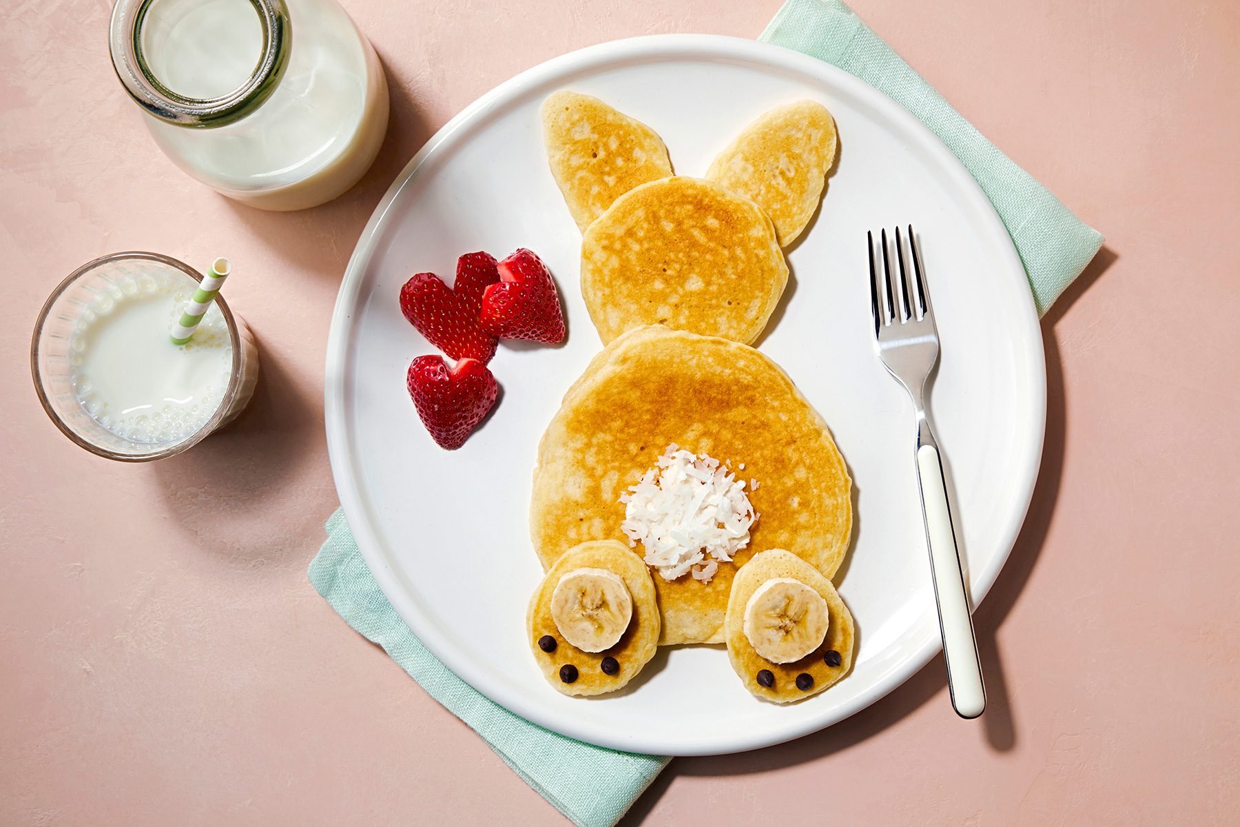 wide shot of fluffy bunny pancakes served with milk