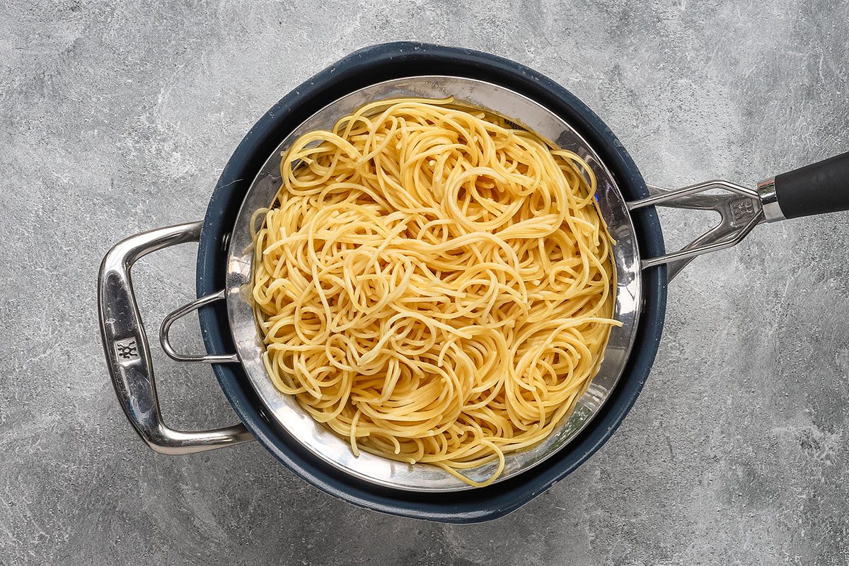 Draining the spaghetti for chicken tetrazzini.