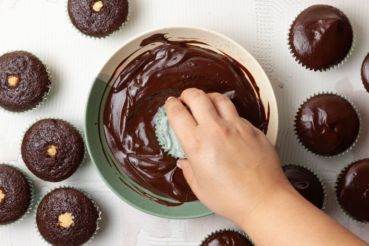 Step 4 of Taste of Home Chocolate Peanut Butter Cupcakes is to place the chocolate chips in a small bowl. In a small saucepan, bring the cream just to a boil. Pour the cream over the chocolate, and whisk until smooth. Dip the top of each cupcake into the ganache.