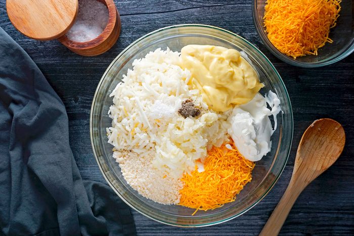 Combining sour cream, Parmesan cheese, salt and pepper in a bowl