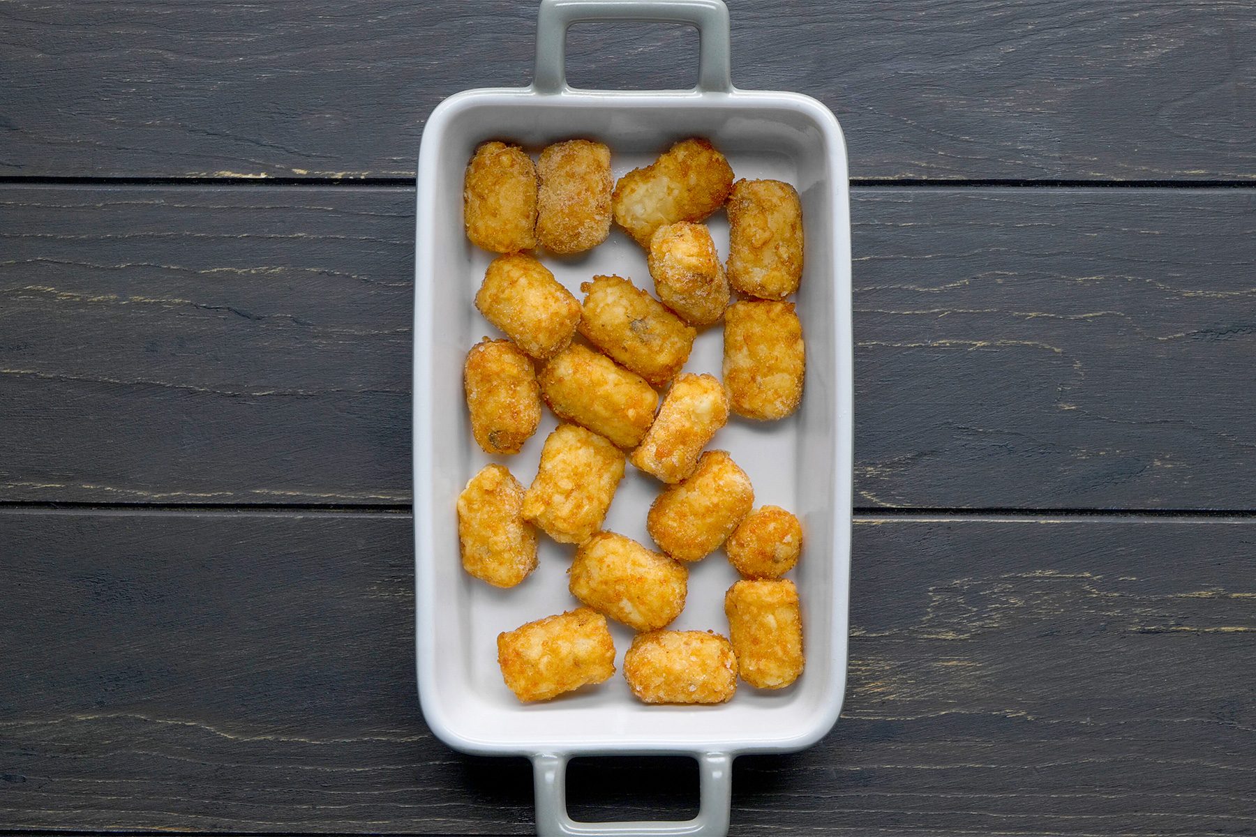 Place Tater Tots in a greased baking dish.